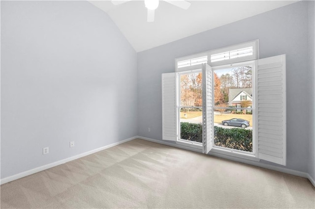 empty room with light carpet, lofted ceiling, and ceiling fan