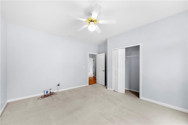 unfurnished bedroom featuring light colored carpet, a closet, and ceiling fan