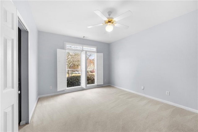 empty room with ceiling fan and light colored carpet