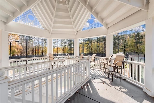 sunroom with vaulted ceiling with beams