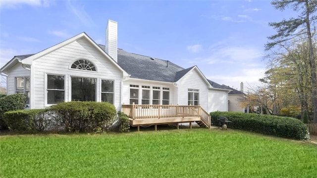 back of house with a wooden deck and a lawn