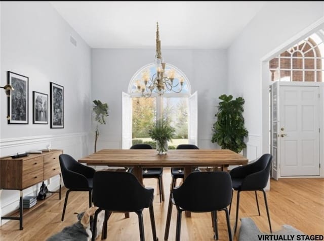 dining room with a chandelier and light hardwood / wood-style floors