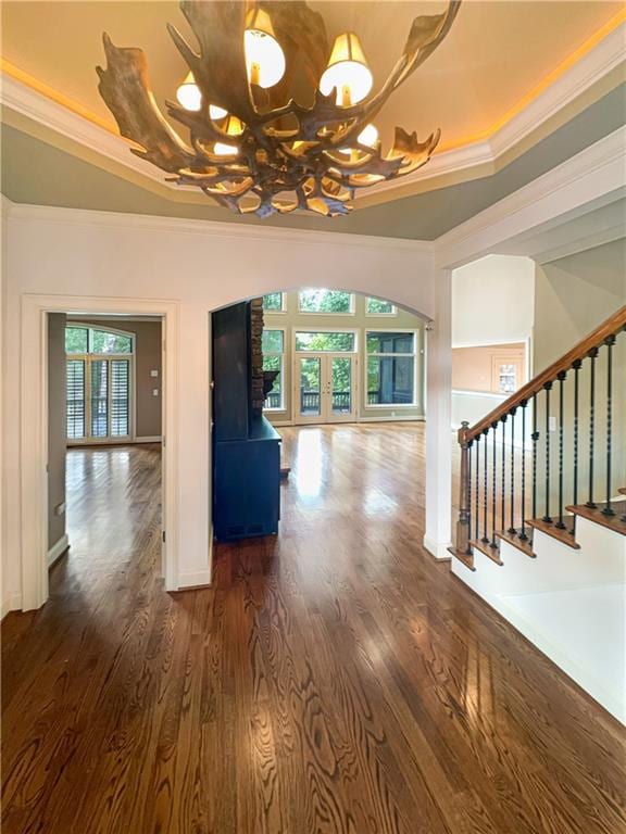 interior space featuring a notable chandelier, dark hardwood / wood-style floors, and crown molding