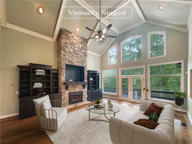 living room with high vaulted ceiling, a fireplace, ceiling fan, hardwood / wood-style flooring, and ornamental molding