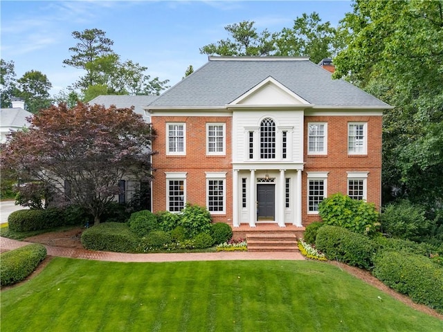 2878 Wesley Heath NW, Atlanta, GA 30327 - colonial house featuring a front lawn, brick siding, a chimney, and roof with shingles