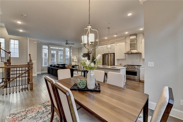 dining area featuring hardwood / wood-style flooring and ceiling fan