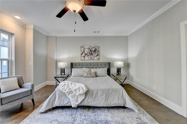 bedroom with ornamental molding, dark hardwood / wood-style flooring, and ceiling fan