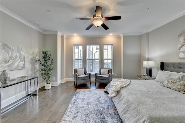 bedroom featuring wood-type flooring, ornamental molding, and ceiling fan