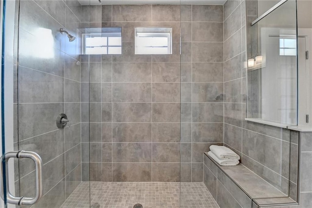 bathroom featuring a shower with door