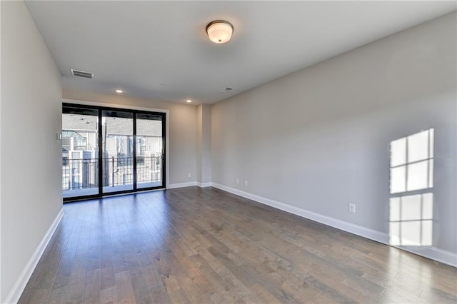 empty room featuring dark hardwood / wood-style flooring