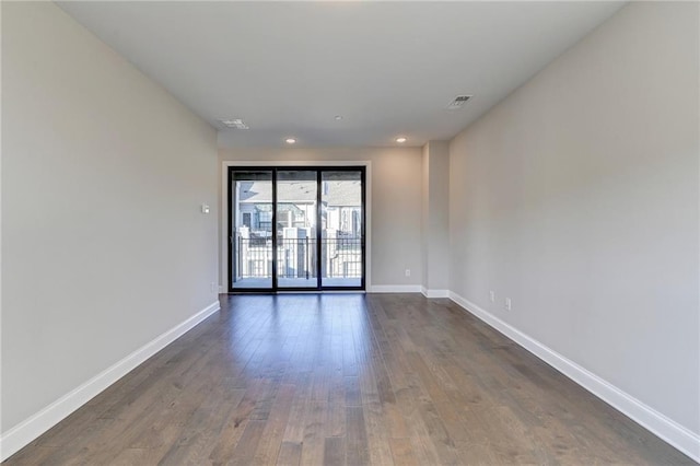 spare room featuring dark wood-type flooring