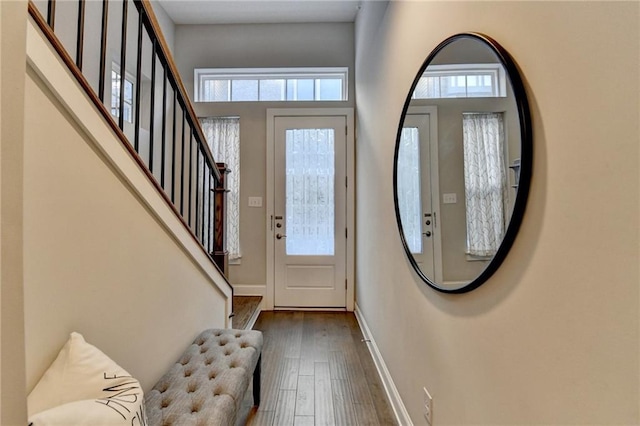 foyer with a towering ceiling and dark hardwood / wood-style flooring