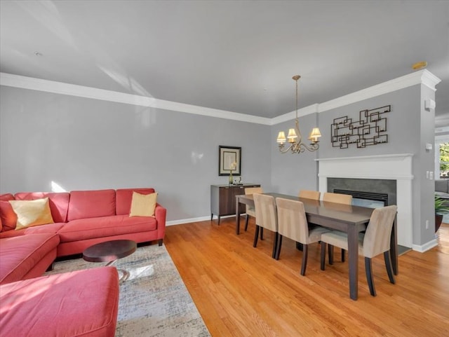 dining space with crown molding, hardwood / wood-style flooring, and a chandelier