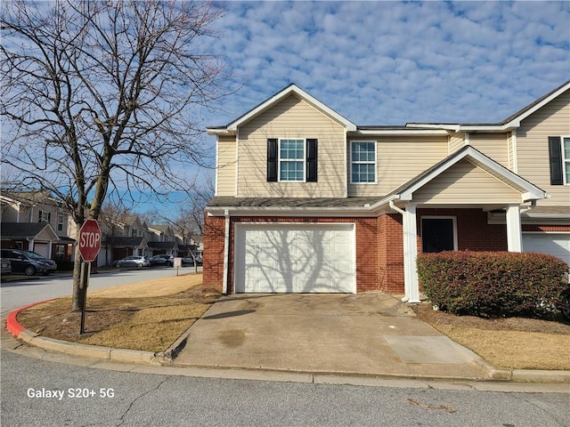 303 Tara Commons Cir, Loganville, GA 30052 - view of front of home featuring an attached garage, brick siding, concrete driveway, and a residential view