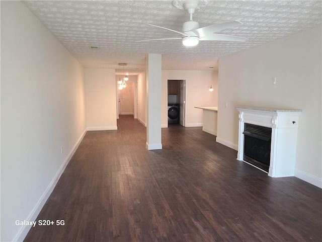 303 Tara Commons Cir, Loganville, GA 30052 - unfurnished living room featuring washer / dryer, dark wood-type flooring, a fireplace, and ceiling fan