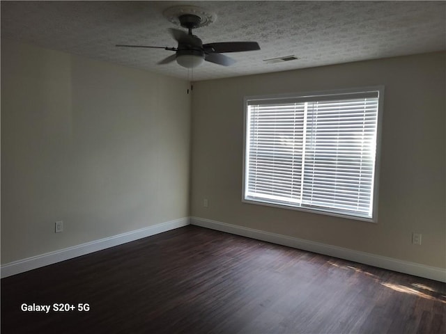 303 Tara Commons Cir, Loganville, GA 30052 - empty room featuring a ceiling fan, dark wood finished floors, and a textured ceiling