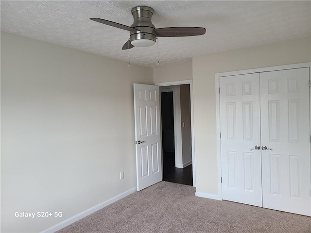 303 Tara Commons Cir, Loganville, GA 30052 - unfurnished bedroom featuring carpet floors, a closet, a textured ceiling, and a ceiling fan