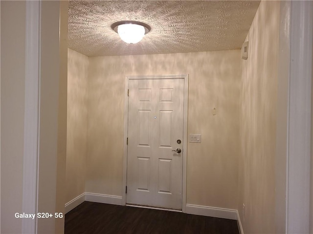 303 Tara Commons Cir, Loganville, GA 30052 - entryway with dark wood-type flooring and a textured ceiling