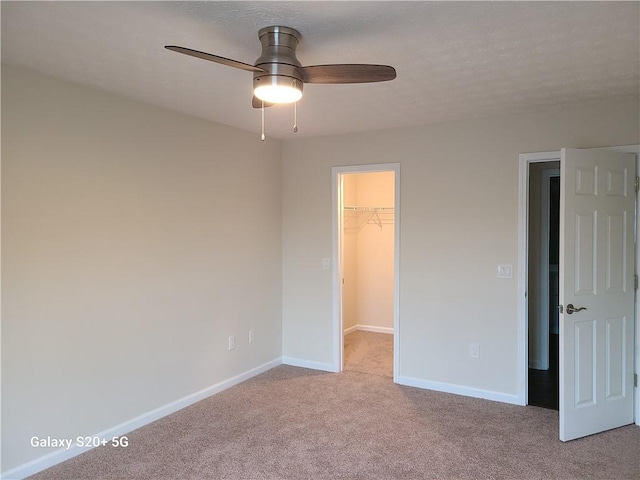 303 Tara Commons Cir, Loganville, GA 30052 - unfurnished bedroom with carpet flooring, a spacious closet, a closet, and a ceiling fan