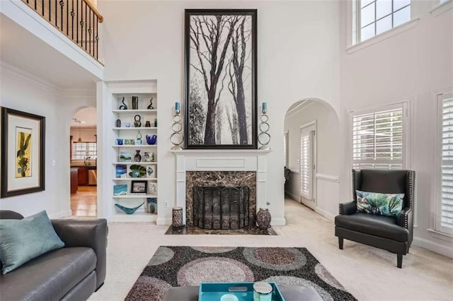 living room featuring a wealth of natural light, carpet, and a high ceiling