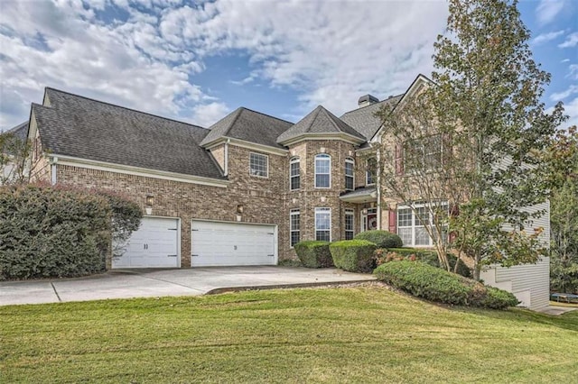 view of front of home with a front yard and a garage