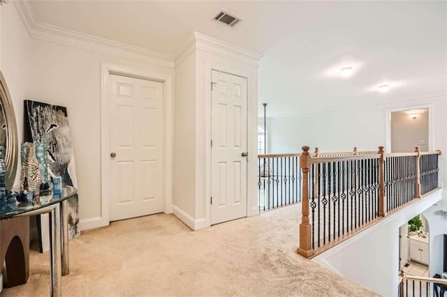 corridor featuring ornamental molding and light colored carpet