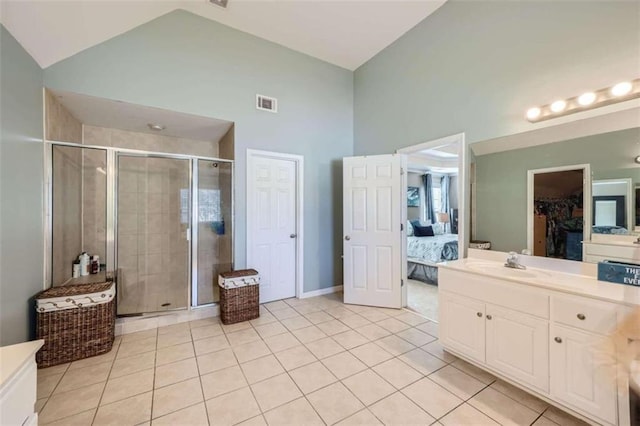 bathroom with vanity, high vaulted ceiling, a shower with shower door, and tile patterned flooring