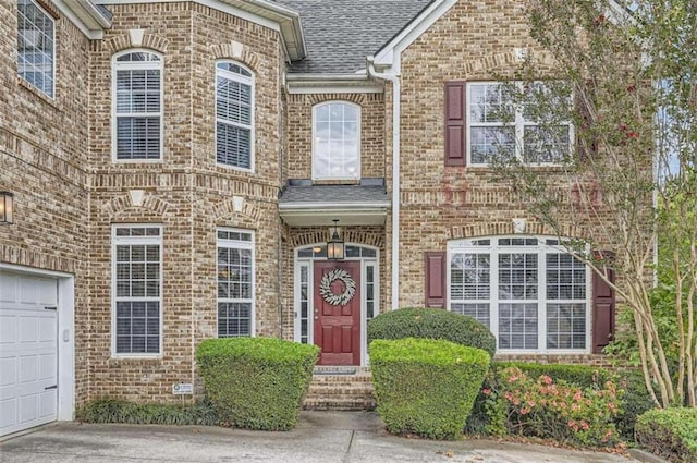 view of exterior entry with a garage