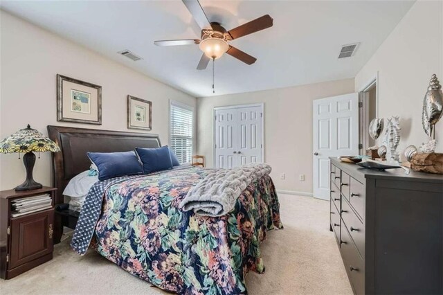 bedroom with light colored carpet, a closet, and ceiling fan