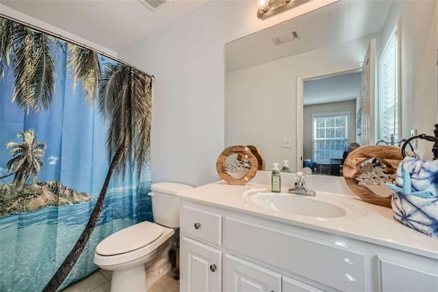 bathroom with vanity, a shower with shower curtain, toilet, and tile patterned floors