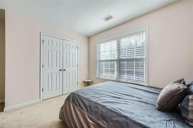 carpeted bedroom featuring a closet