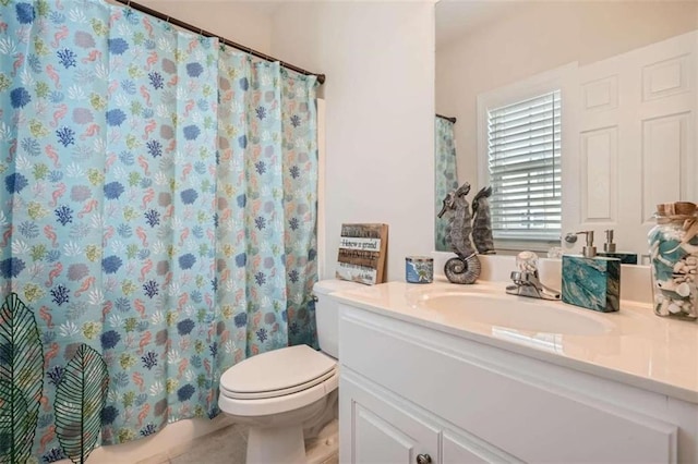 bathroom featuring vanity, curtained shower, toilet, and tile patterned flooring