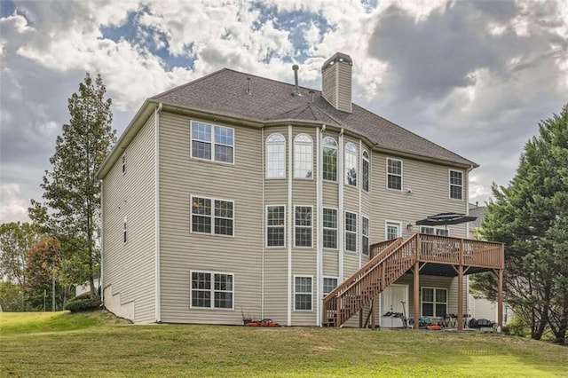 back of house with a yard and a deck