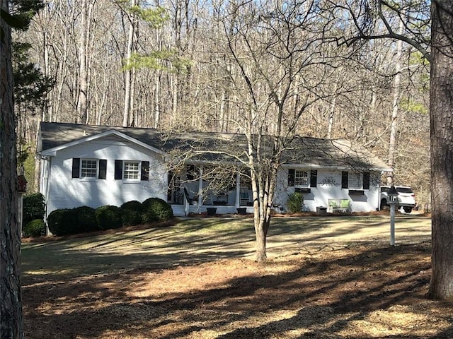 single story home with brick siding and a front yard