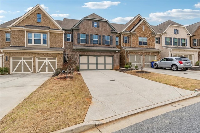 view of front of home featuring brick siding, an attached garage, and driveway