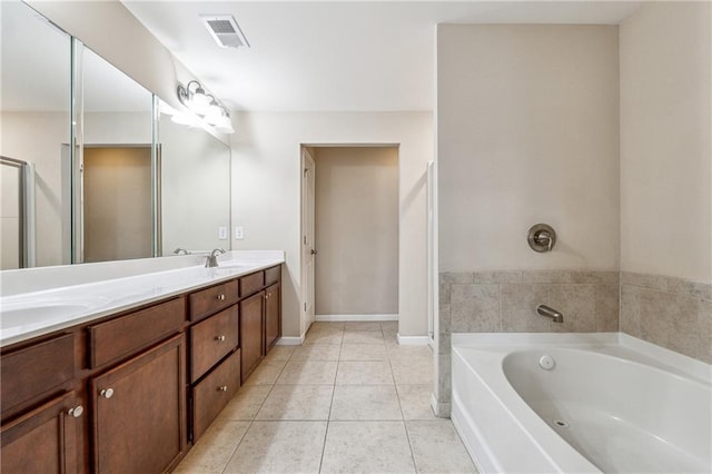 bathroom featuring visible vents, double vanity, a sink, tile patterned flooring, and a garden tub