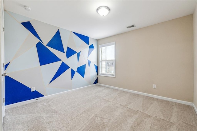 unfurnished room featuring visible vents, baseboards, and carpet flooring