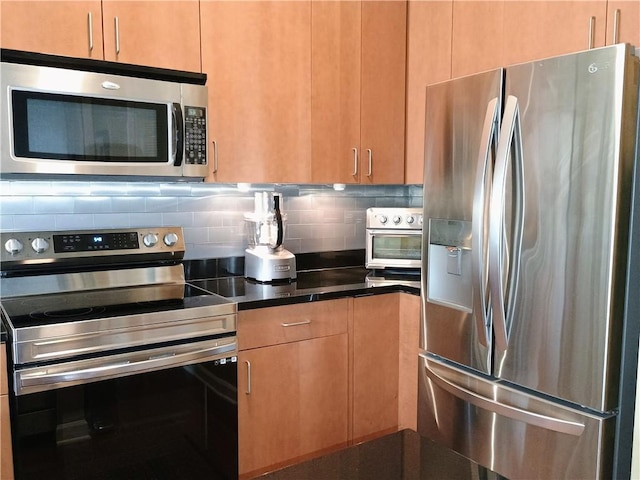 711 Cosmopolitan Dr NE Unit 123, Atlanta, GA 30324 - kitchen featuring appliances with stainless steel finishes, tasteful backsplash, and dark countertops