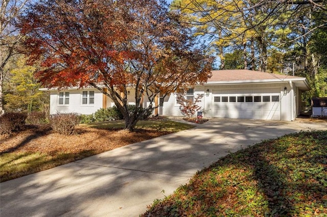 view of property hidden behind natural elements with a garage