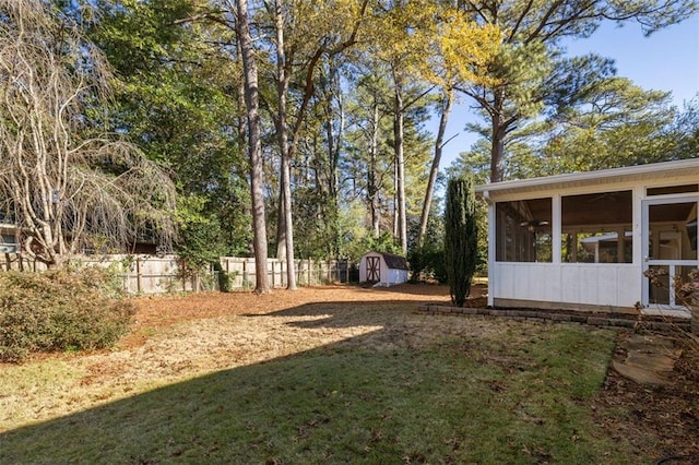 view of yard with a sunroom and a storage shed