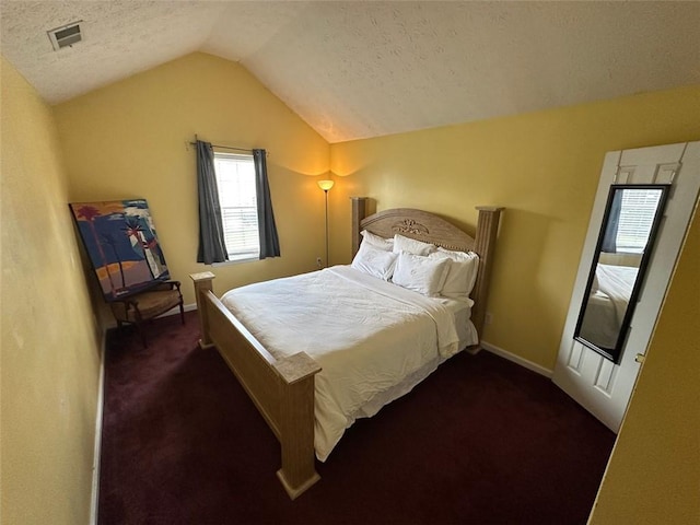 5546 Wellborn Creek Dr, Lithonia, GA 30058 - carpeted bedroom featuring vaulted ceiling, a textured ceiling, and baseboards