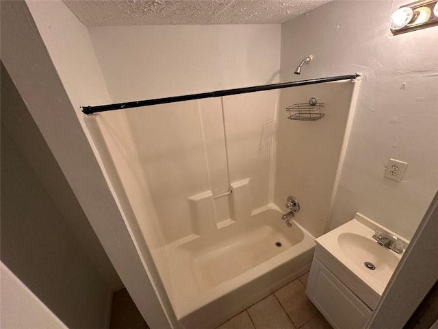 5546 Wellborn Creek Dr, Lithonia, GA 30058 - bathroom featuring a textured ceiling, bathing tub / shower combination, vanity, and tile patterned floors
