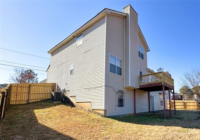 5546 Wellborn Creek Dr, Lithonia, GA 30058 - view of property exterior featuring a chimney, central AC unit, and a wooden deck