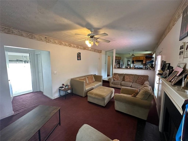 5546 Wellborn Creek Dr, Lithonia, GA 30058 - living room with a textured ceiling, carpet flooring, ceiling fan, a fireplace, and baseboards