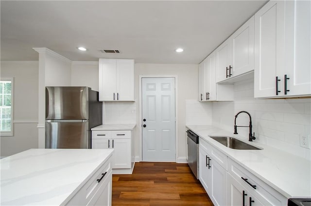 kitchen with light stone countertops, a sink, stainless steel appliances, recessed lighting, and visible vents