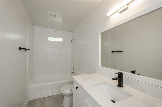 full bathroom with vanity, toilet, and tiled shower / bath combo