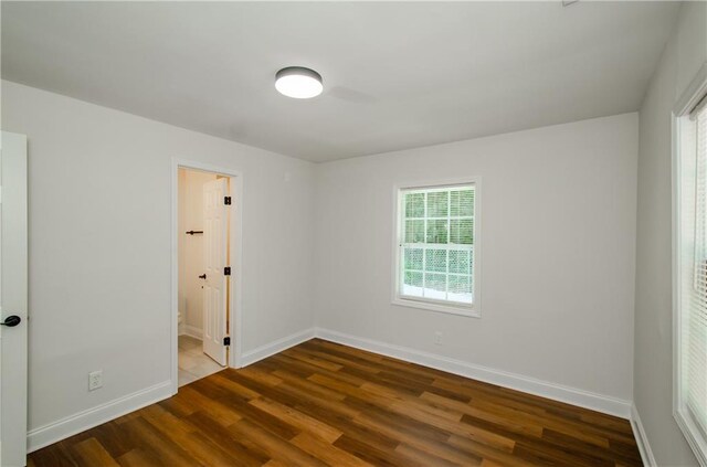 empty room featuring hardwood / wood-style flooring and a healthy amount of sunlight