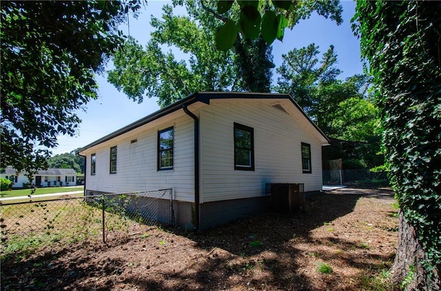 view of side of property featuring fence and cooling unit