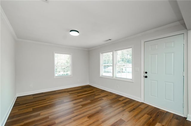 entrance foyer with crown molding, plenty of natural light, wood finished floors, and visible vents