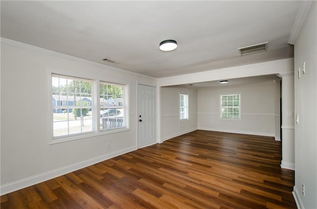entrance foyer featuring visible vents, ornamental molding, baseboards, and wood finished floors